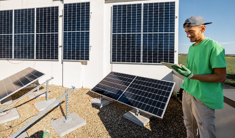 Solar Installer creating invoice on phone at customer site in South Africa